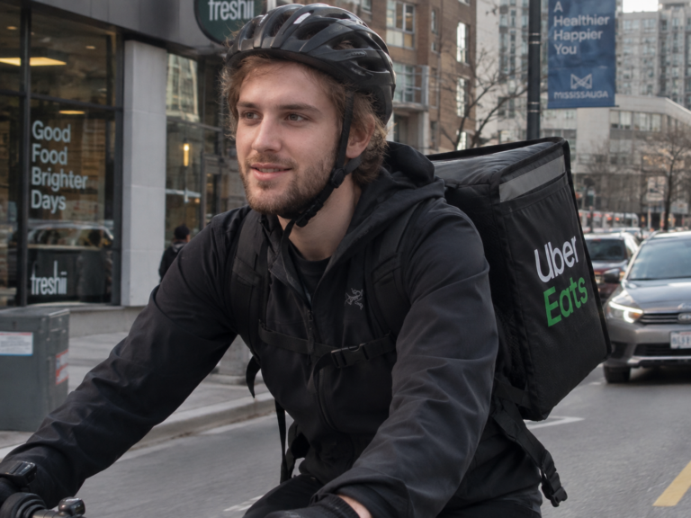 Student making a delivery by bicycle.